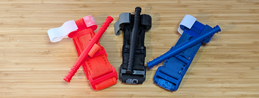 A display of three differently colored tourniquets